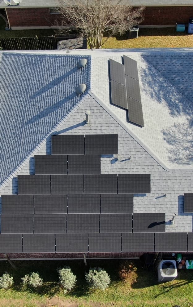 Aerial view of completed roof with solar panel installation in Central Texas